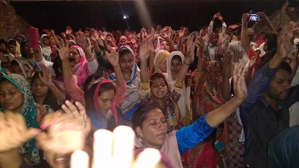 Night revival meeting filled with worship and prayer